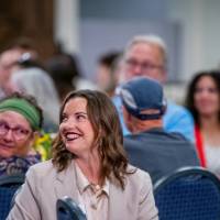 Audience member listening to speaker 2